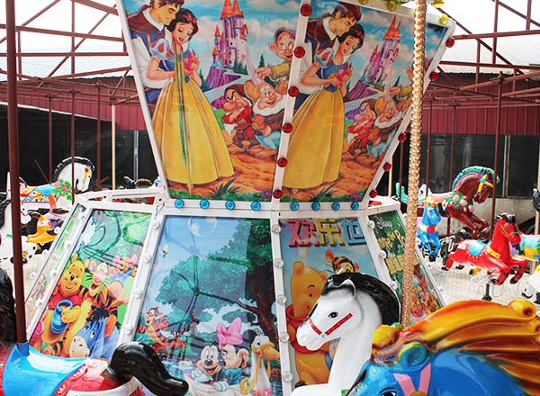 Luxury double decker merry go round carousel installation in progress with colorful horse figures and Disney-themed design