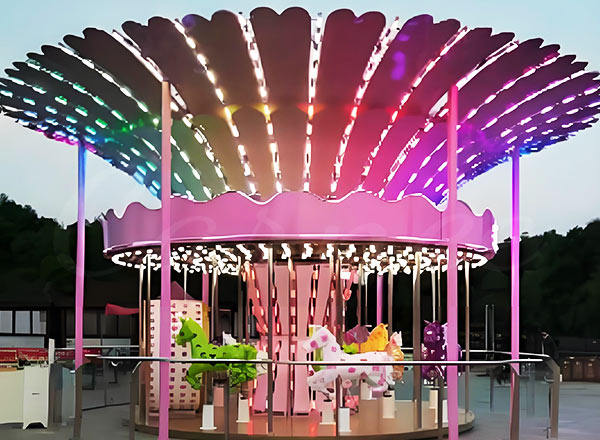 Magical themed mini carousel ride with lights and colorful decorations for family entertainment.