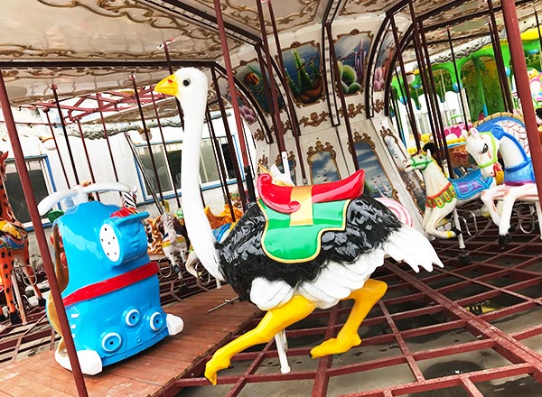 Ostrich figure on a carousel, part of an exciting theme park ride with various animal designs