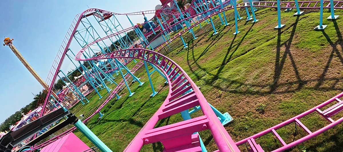 Pink track family roller coaster for kids & adults manufactured by Carnee Rides, suitable for theme parks and family entertainment centers.