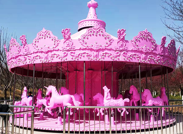 Pink princess carousel for kids in an amusement park setting by carnee rides