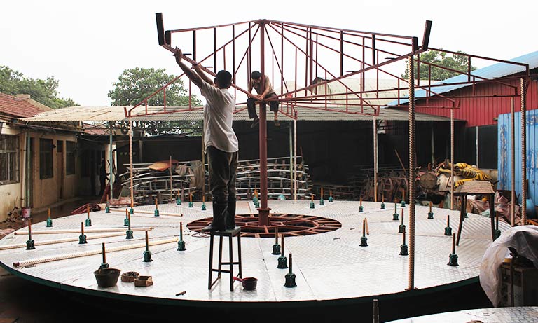 On-site installation of Carnee Rides two-storey amusement park merry go round with engineers assembling the steel structure and providing technical support at the customer’s venue