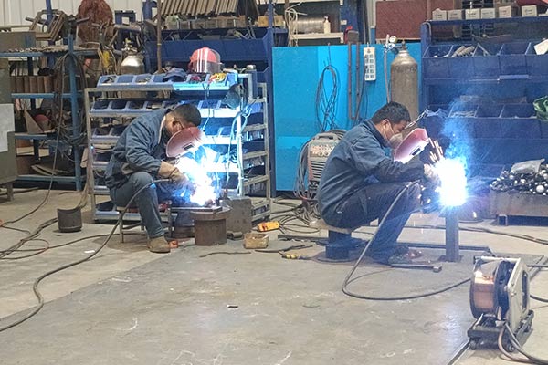 Welding technicians working on amusement ride components, ensuring precise and high-quality welding for safety and durability.