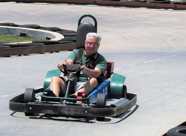 Adult driver operating a go-kart on a dedicated racing track