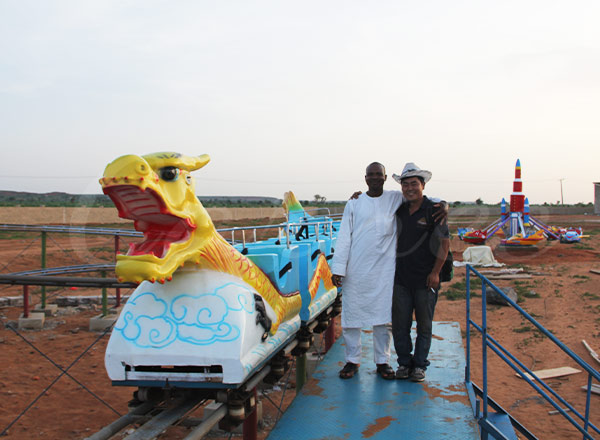 Completed Dragon Coaster ride project in Nigeria with client and installation engineer