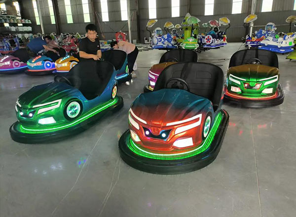 Indoor bumper car arena with multiple cars operating under safety rules