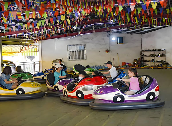 Indoor bumper car arena in operation with multiple riders