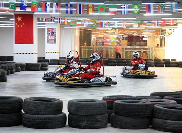 Indoor go-kart track with safety barriers and racing layout