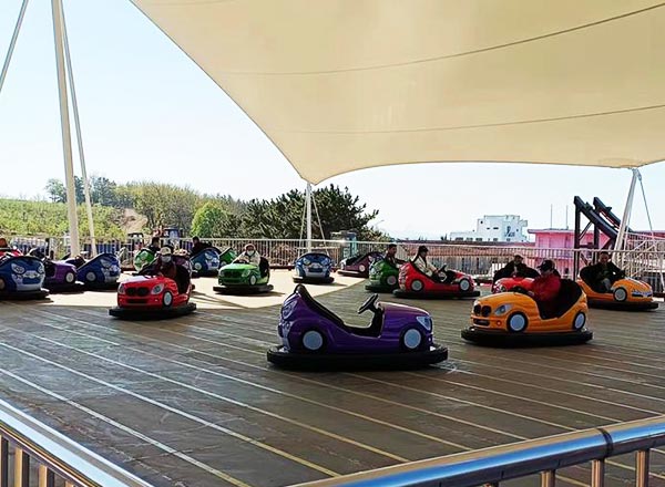 Large bumper cars area with multiple cars operating simultaneously