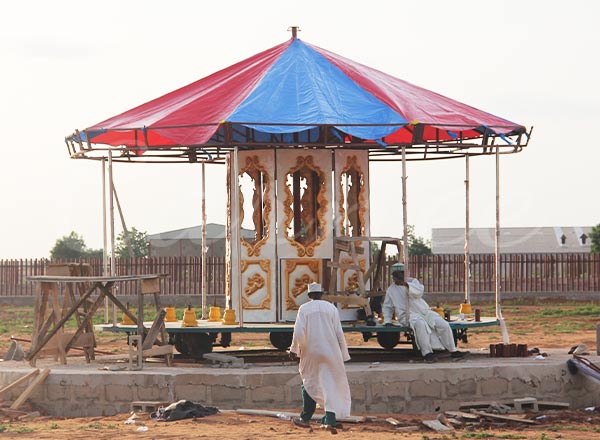 merry go round carousel ride structure installation at an outdoor site in Tanzania